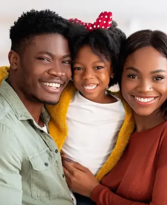 Family portrait of smiling parents and their child