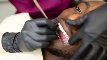 Doctor treating a patient's teeth in the clinic