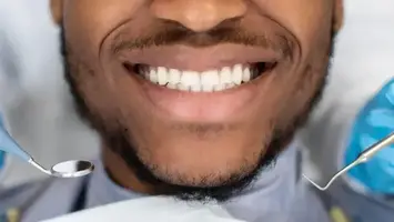 Smiling patient receiving a whitening treatment